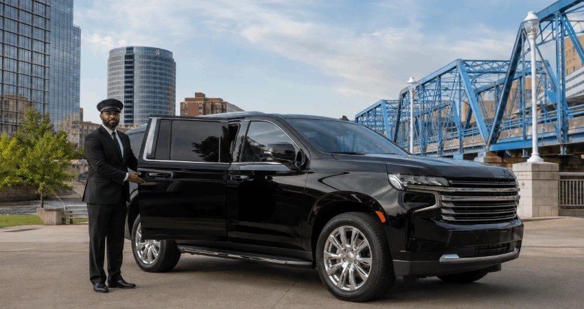 Chauffeur by the sleek SUV